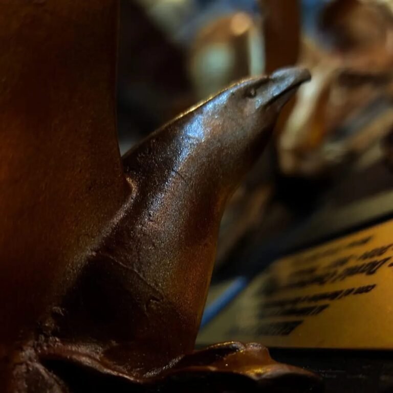 Trofeo de halcón en bronce sobre base de madera para premios institucionales